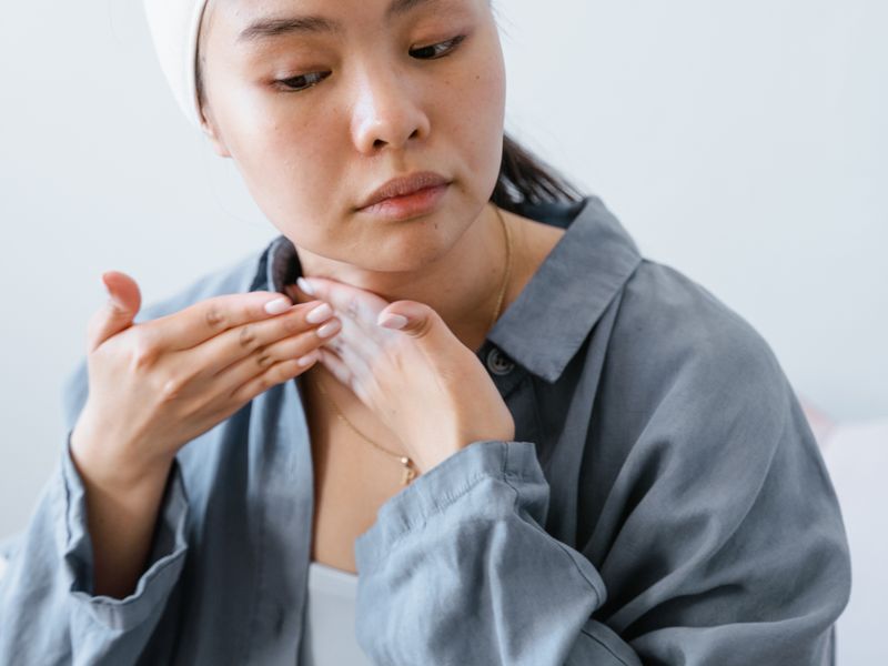 Cô gái châu Á thoa sản phẩm phục hồi tại nhà sau liệu trình vi kim
